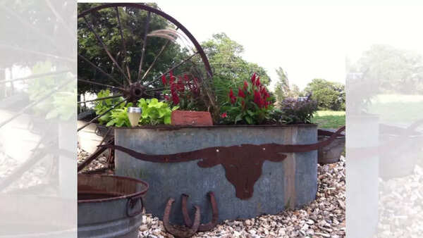 Vintage metal trough planter with flowers