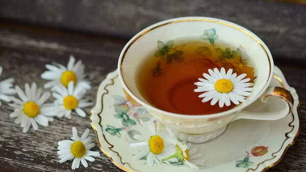 Cup of chamomile tea with chamomile flowers